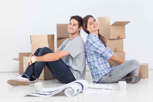 Movers carrying furniture through a Fulham apartment building