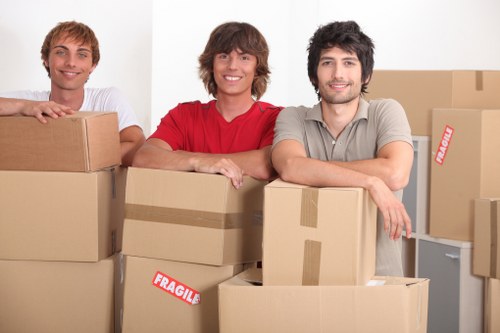 Packed moving boxes and furniture ready for collection in Fulham