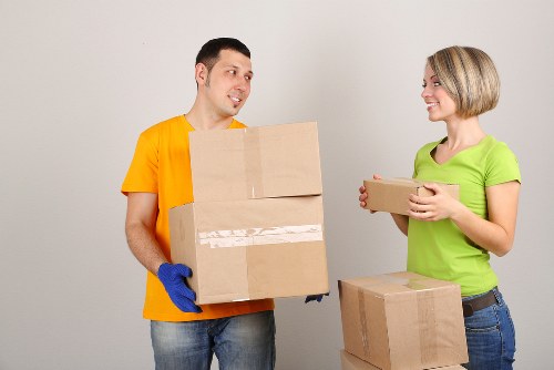 Professional movers packing boxes for a house move in Fulham